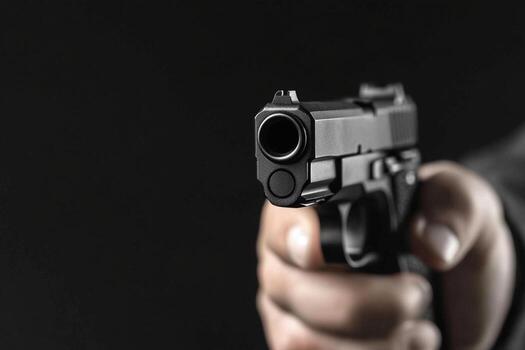 1785273918 a person holding a gun in their hand photo