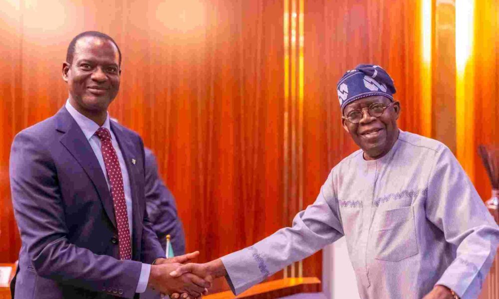 File photo of the Finance Minister Taiwo Oyedele shaking hands with President Tinubu