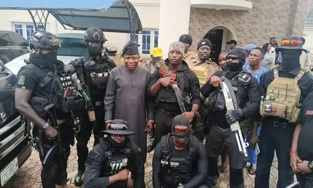 Sunday Igboho in black native attire flanked by members of his Iru Ekun Security team during the lau