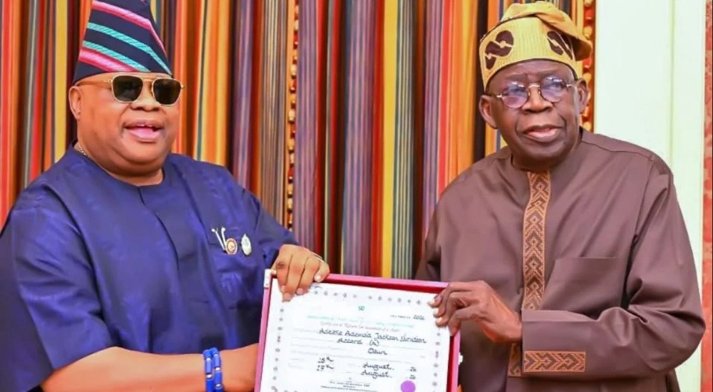 Osun State Governor Ademola Adeleke presenting his return certificate to President Bola Tinubu at th